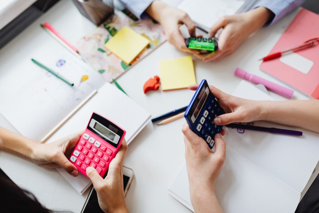 Students working on math problems using calculators in a group