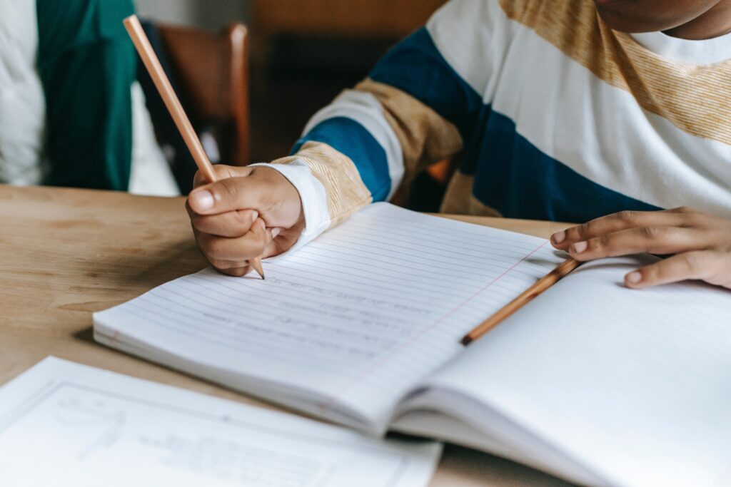 student writing in notebook